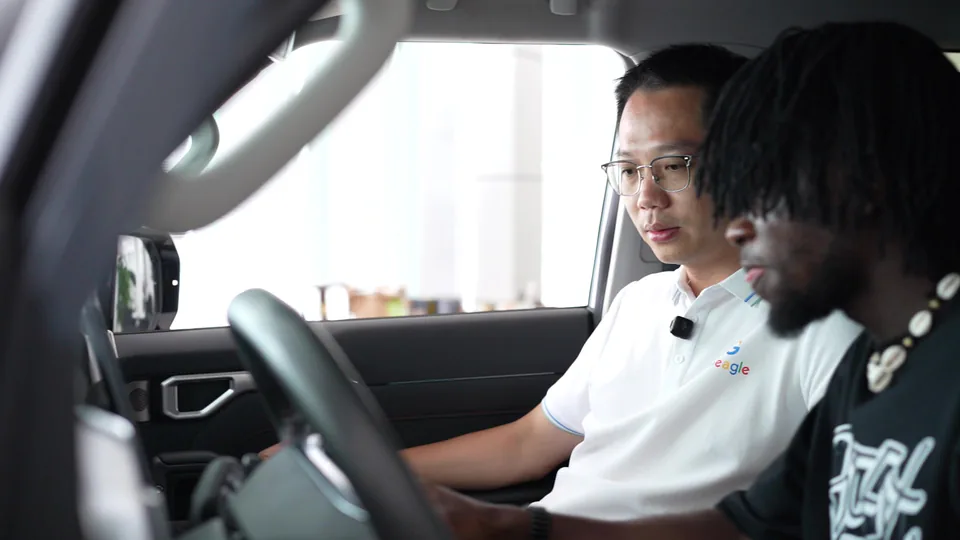 Two people reviewing a vehicle cockpit together