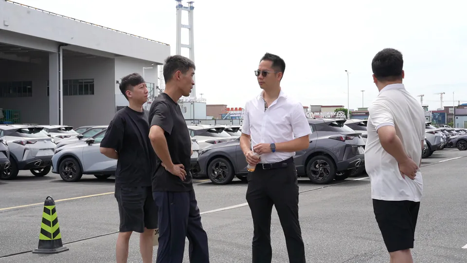 A group talking together at a vehicle yard