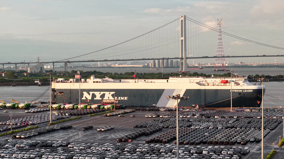 A roll-on roll-off ship beside a vehicle terminal and bridge