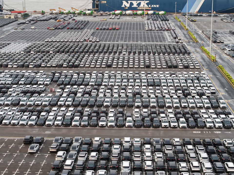 Aerial view of vehicle rows and ships at a terminal